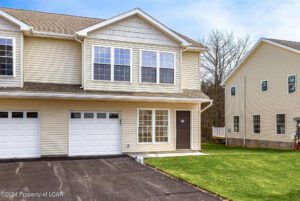 Contemporary 3-bedroom townhome with attached garage, master suite, walk-out deck, functional kitchen with granite countertops, and spacious pantry in Hazleton, PA.